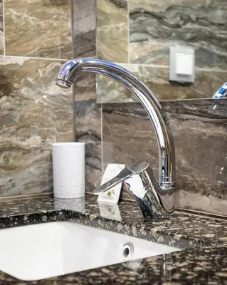 a kitchen sink with a faucet on a counter at Sunny Apartment in Studentski grad, behind UNSS in Sofia