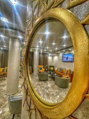 a mirror reflecting a living room with couches at Hotel CITY Petrich in Petrich