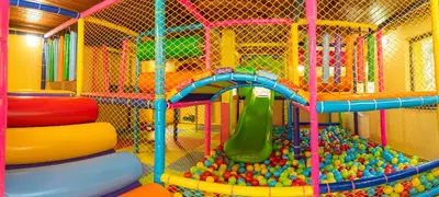 a childrens play room with a slide and a playground at Почивна станция Сомат in Dospat