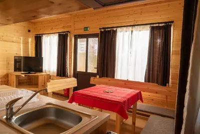 a kitchen with a sink and a table with a red towel at Почивна станция Сомат in Dospat
