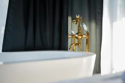 a white table with a gold trophy in front of a mirror at THE HIDDEN BANK: Silver Bullet in Plovdiv