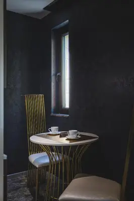 a table and chairs in a room with a window at THE HIDDEN BANK: Silver Bullet in Plovdiv