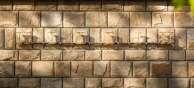 a brick wall with the shadows of chairs on it at THE HIDDEN BANK: Silver Bullet in Plovdiv
