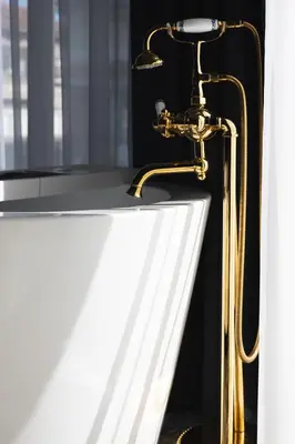 a bathroom sink with a gold faucet at THE HIDDEN BANK: Silver Bullet in Plovdiv