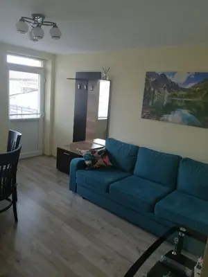 a living room with a blue couch and a table at дом Тодор и Тота Мутевски in Troyan