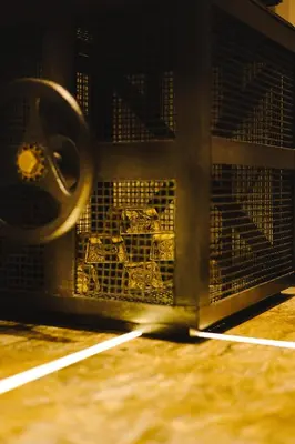 a close up of a metal cage with a mechanism at HIDDEN BANK: Golden in Plovdiv
