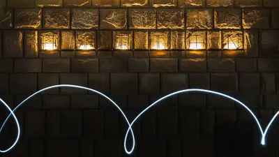 two hearts are drawn in front of a brick wall with lights at HIDDEN BANK: Golden in Plovdiv
