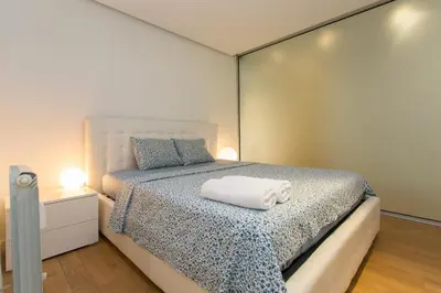 a bedroom with a bed with two towels on it at Modern Apartment in the City Center in Sofia