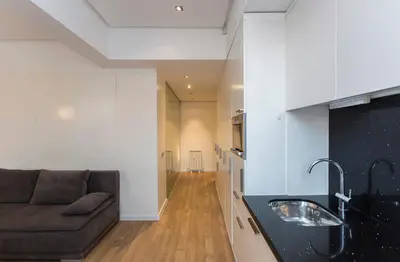 a living room with a couch and a sink at Modern Apartment in the City Center in Sofia