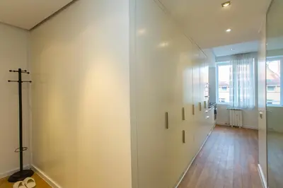 a hallway with white walls and a cross on the wall at Modern Apartment in the City Center in Sofia