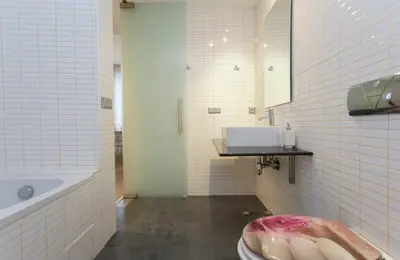 a bathroom with a toilet and a sink and a tub at Modern Apartment in the City Center in Sofia