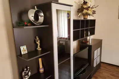 a black and white book shelf with a mirror at Двете къщи в планината in Beli Osŭm