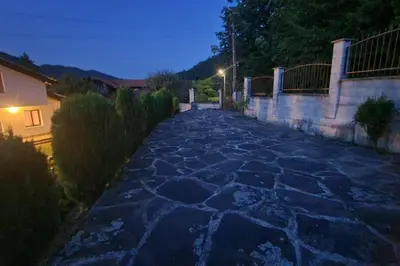 a stone pathway at night with a street at Двете къщи в планината in Beli Osŭm