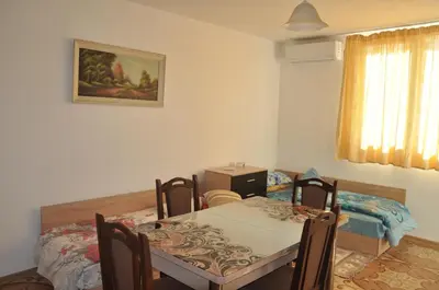 a dining room with a table and two chairs at Al Colosseo in Zvŭnichevo