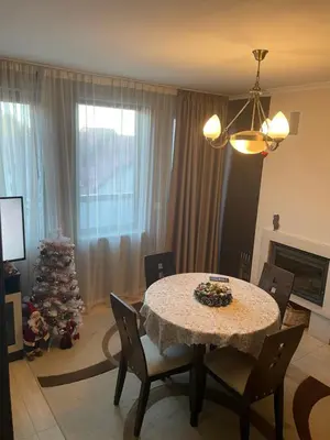 a dining room with a table and a christmas tree at Гранд Манастира Пампорово in Pamporovo
