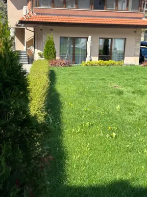a shadow of a house on a lawn at Stella Guesthouse in Sapareva Banya