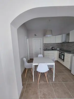 a kitchen with a table and chairs in a room at Stella Guesthouse in Sapareva Banya
