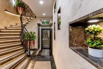 a hallway with stairs and potted plants at SOHO Apart House in Plovdiv