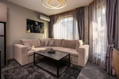 a living room with a couch and a table at SOHO Apart House in Plovdiv