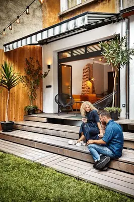 a man and woman sitting on the steps of a house at COURTHOUSE #4 EXCLUSIVE Top Center PRIVATE GARDEN in Sofia
