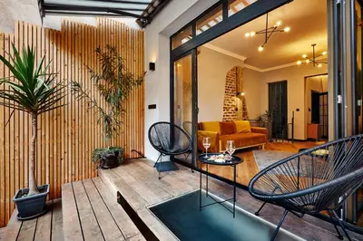 a porch with chairs and a living room at COURTHOUSE #4 EXCLUSIVE Top Center PRIVATE GARDEN in Sofia