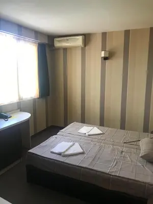 a bedroom with a large bed with towels on it at Casa Blanca in Sofia