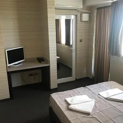 a bedroom with a bed and a desk with a computer at Casa Blanca in Sofia
