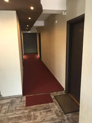 an empty hallway in a building with a door open at Casa Blanca in Sofia