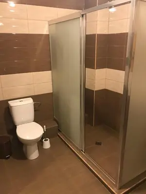a bathroom with a toilet and a glass shower at Casa Blanca in Sofia