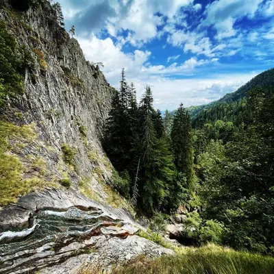 a view of a mountain with a river and trees at Музикалната къща in Breze