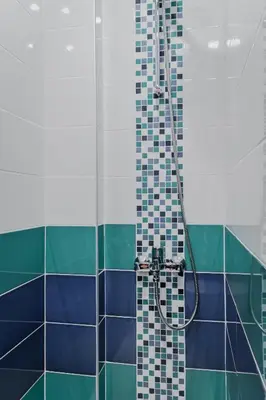 a bathroom with a shower with blue and green tiles at Bright Apartment in the Heart of the City by Flat Mаnager in Sofia
