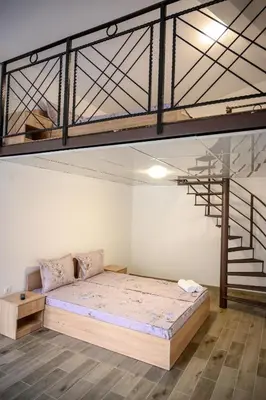 a bedroom with a bunk bed and a staircase at Апартаменти ЗДРАВЕ in Sapareva Banya