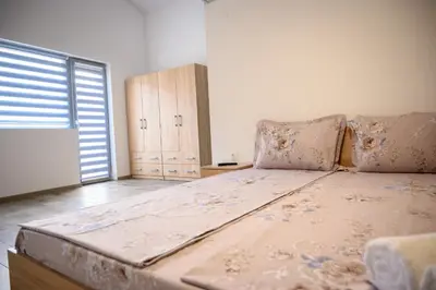 a large bed in a room with a large window at Апартаменти ЗДРАВЕ in Sapareva Banya