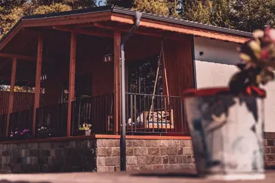 a vase with flowers in front of a building at Dakota forest retreat in Tsigov Chark