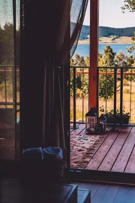 a room with a window looking out onto a deck at Dakota forest retreat in Tsigov Chark