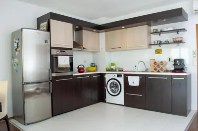 a kitchen with a stainless steel refrigerator and a dishwasher at Central Apartment Mountain View in Karlovo