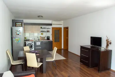a kitchen and dining room with a table and chairs at Central Apartment Mountain View in Karlovo