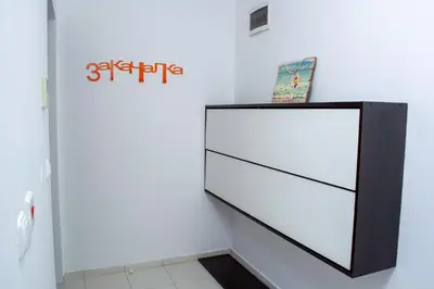 a large white dresser in a white room at Central Apartment Mountain View in Karlovo