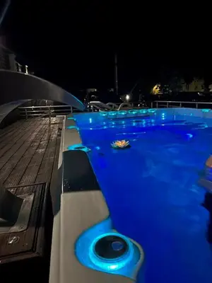 a swimming pool with blue lights in the night at Луксозна вила - Стрелча, джакузи с минерална вода in Strelcha