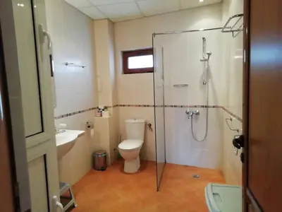 a bathroom with a shower and a toilet and a sink at Къща в центъра на Стрелча, джакузи с минерална вода in Strelcha
