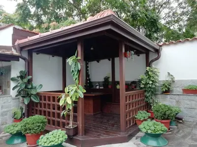 a wooden gazebo with plants in pots at Къща в центъра на Стрелча, джакузи с минерална вода in Strelcha