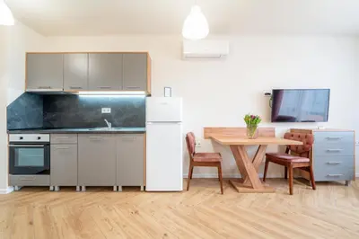a kitchen and dining room with a table and a refrigerator at WOW studios for rent 2 bul Montevideo 25A - B in Sofia