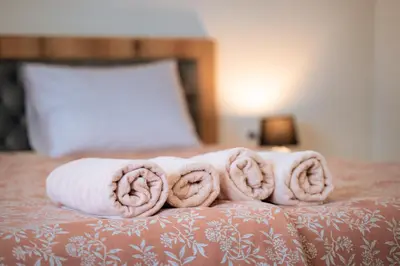a pile of towels on top of a bed at WOW studios for rent 2 bul Montevideo 25A - B in Sofia