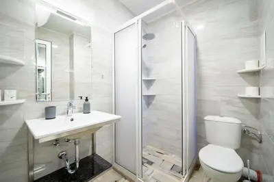 a bathroom with a toilet and a sink and a shower at WOW studios for rent 2 bul Montevideo 25A - B in Sofia