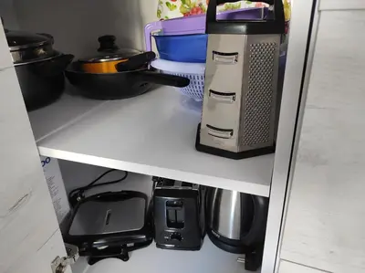 a refrigerator shelf with various kitchen appliances on it at IGLIKA 2 SNOWY NIGHT V 31 in Borovets