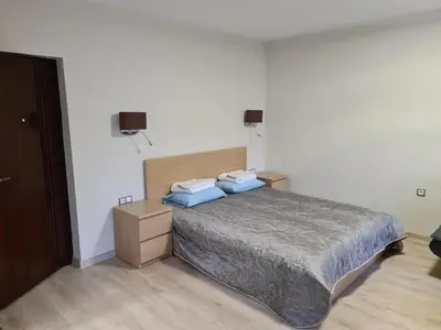 a bedroom with a bed with blue pillows on it at Студиа Студенец in Smolyan