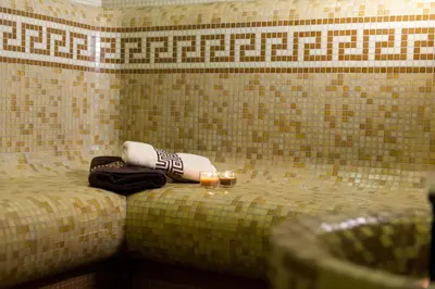 a room with two towels and candles on a bed at Hotel Astrea in Hisarya