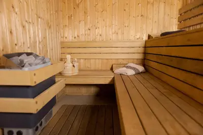 a sauna with a bench in a wooden room at Hotel Astrea in Hisarya