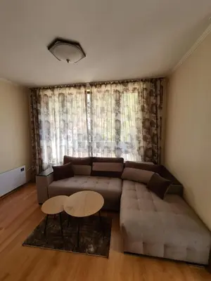 a living room with a couch and a table at Родопски Рай in Pamporovo