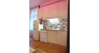 a kitchen with white cabinets and a white refrigerator at Balkan Rooms & Studios in Downtown in Sofia